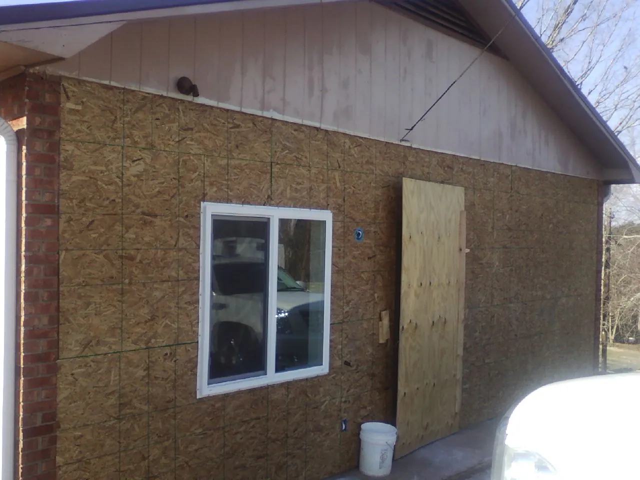 OSB sheathing on a garage addition wall before siding in Arkville