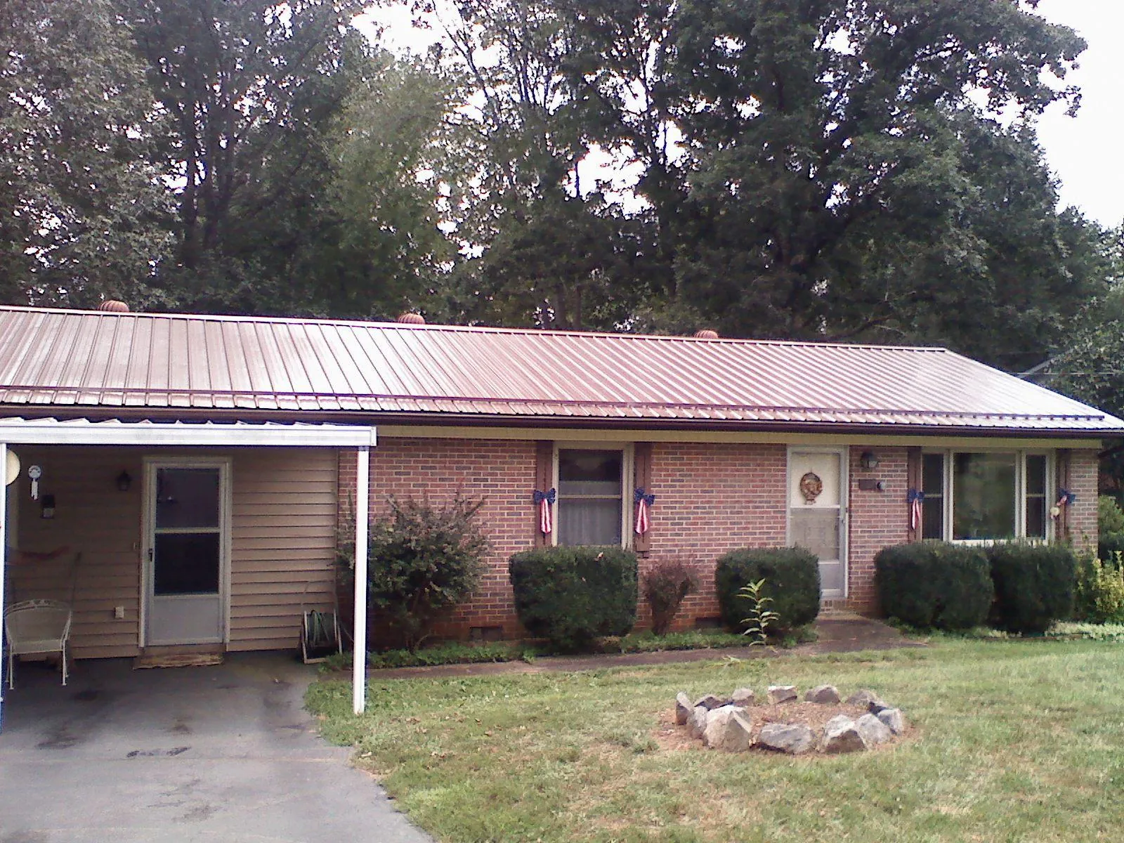 Bronze metal roof and carport on a brick ranch home — Roof Repair work by our crew in Arkville